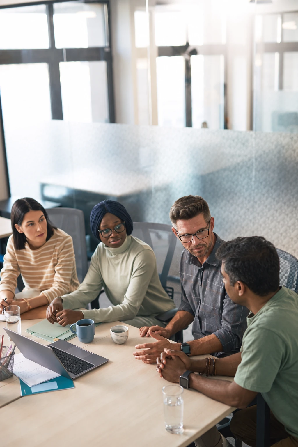 Four colleagues sharing perspectives during a team discussion